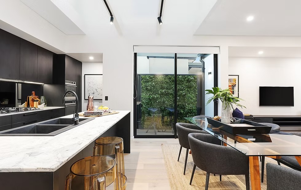 Modern kitchen and living area with LED lighting.