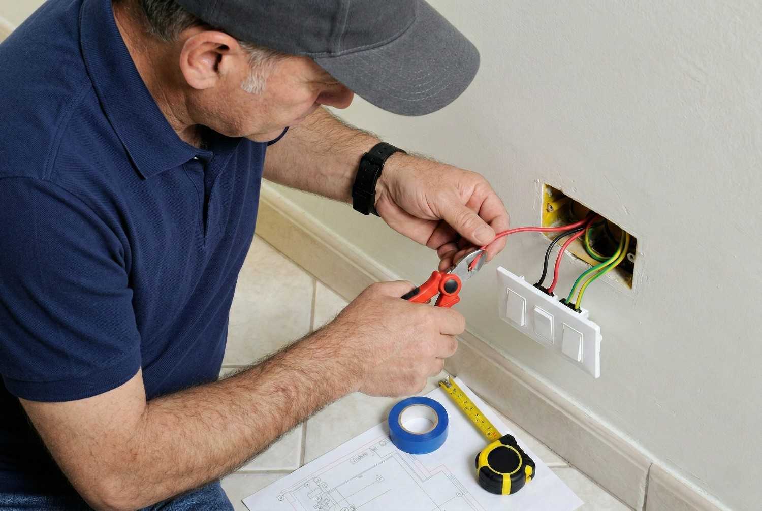 Professional electrician working on electrical panel