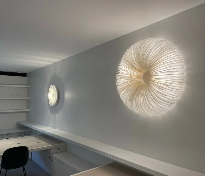 Textured circular wall light creating soft ambient glow.