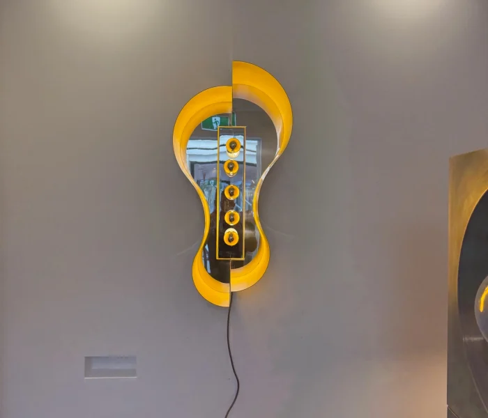 Artistic yellow wall light creating vibrant halo effect.