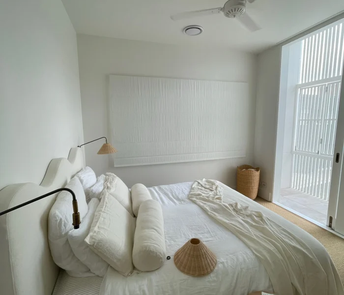 Soft neutral bedroom with minimalist décor and natural light.