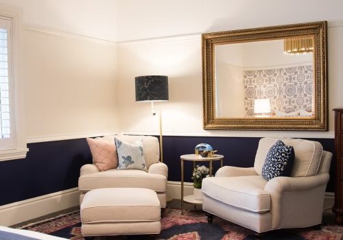 Lounge room with feature lighting and wall lamp.