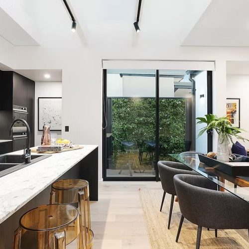 Modern kitchen and living area with LED lighting.